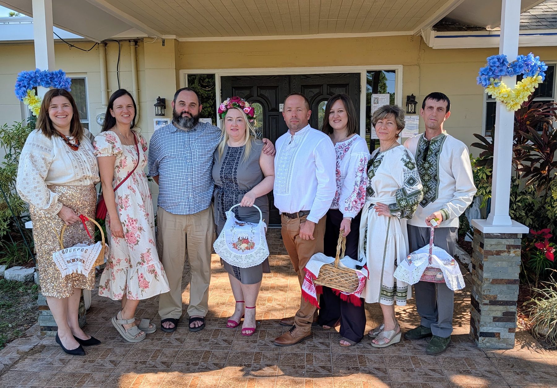 Parish family gathered at the church entrance with their baskets