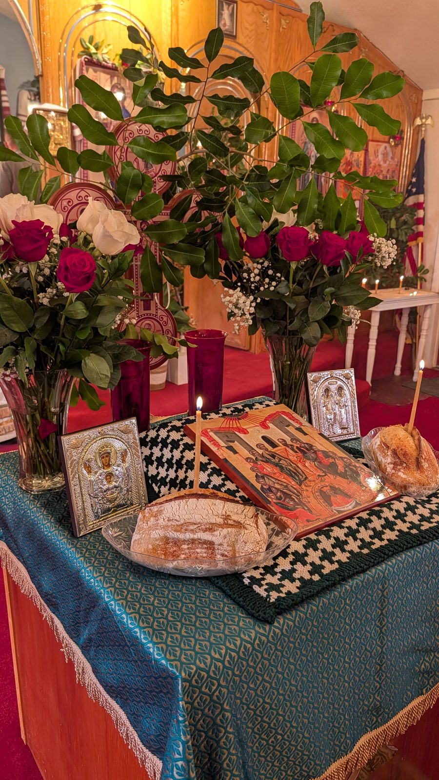 Tetrapod with prosphora and the Pentecost icon, the American flag and altar behind