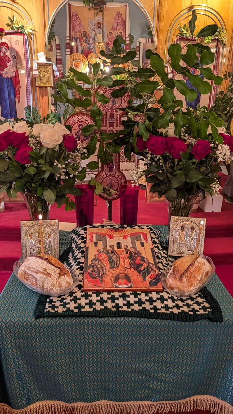 The tetrapod at St. Michael, dressed with flowers, icons, and candles for the feast of Pentecost.