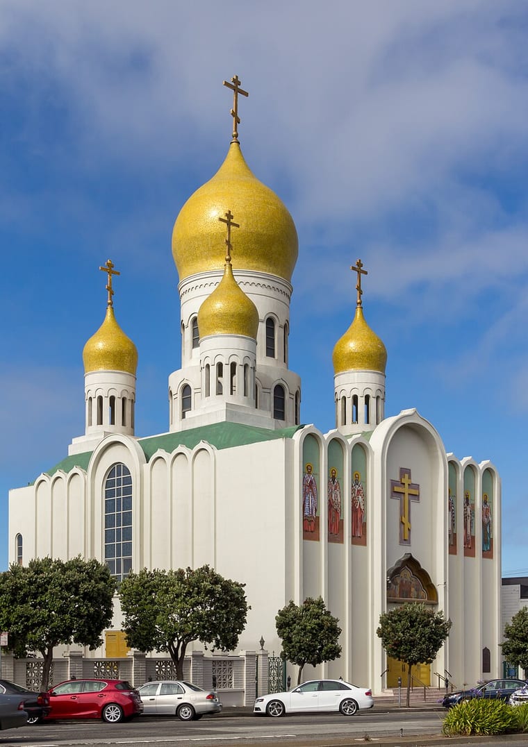 Exterior of the Holy Virgin Cathedral, Joy of All Who Sorrow, in San Francisco, a white cathedral with five gold onion domes and Orthodox crosses, where Saint John's relics rest